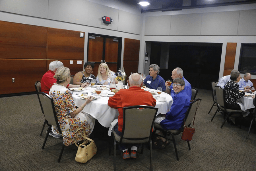 members and guests discussing at a luncheon